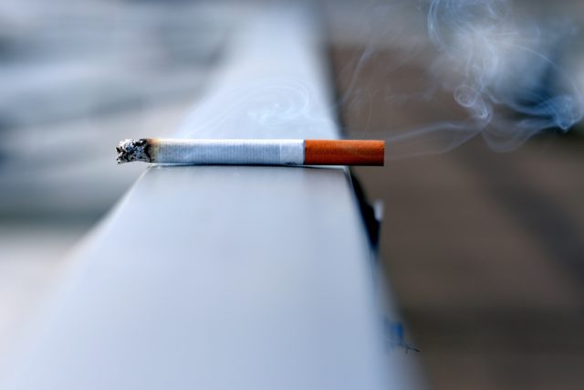 A picture of a smoking cigarette, a cause of lung cancer
